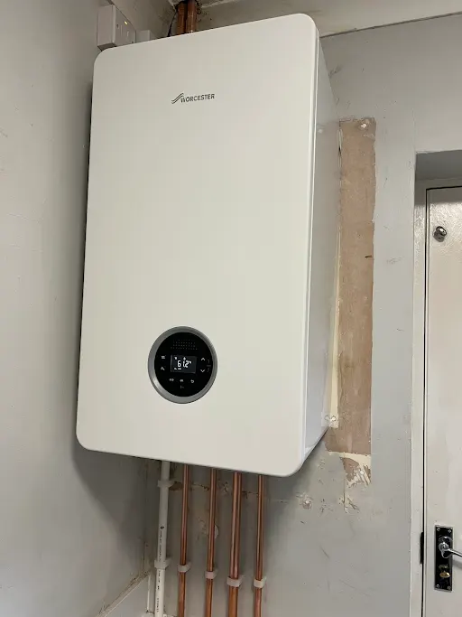 Worcester Bosch boiler installed in utility room with insulated pipework