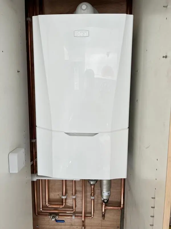 Ideal Vogue boiler installed in cupboard with neat copper pipework
