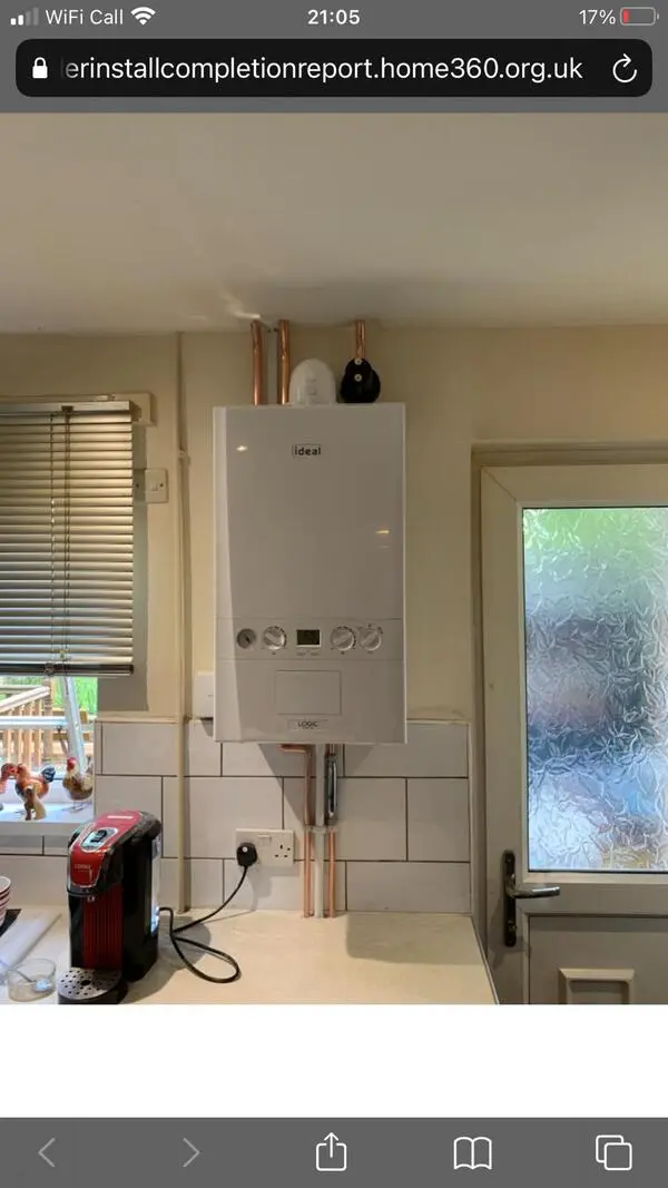 Ideal Logic boiler installation in kitchen — wider view showing workspace