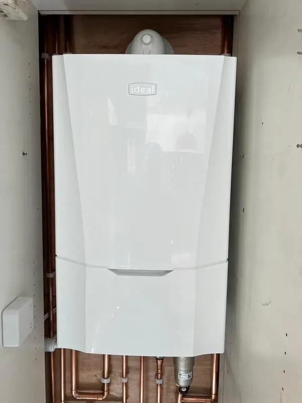 Ideal Vogue boiler installed in cupboard with neat copper pipework
