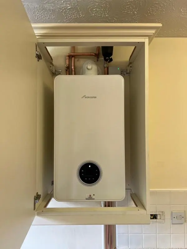 Worcester Bosch boiler fitted in kitchen wall cupboard with filter